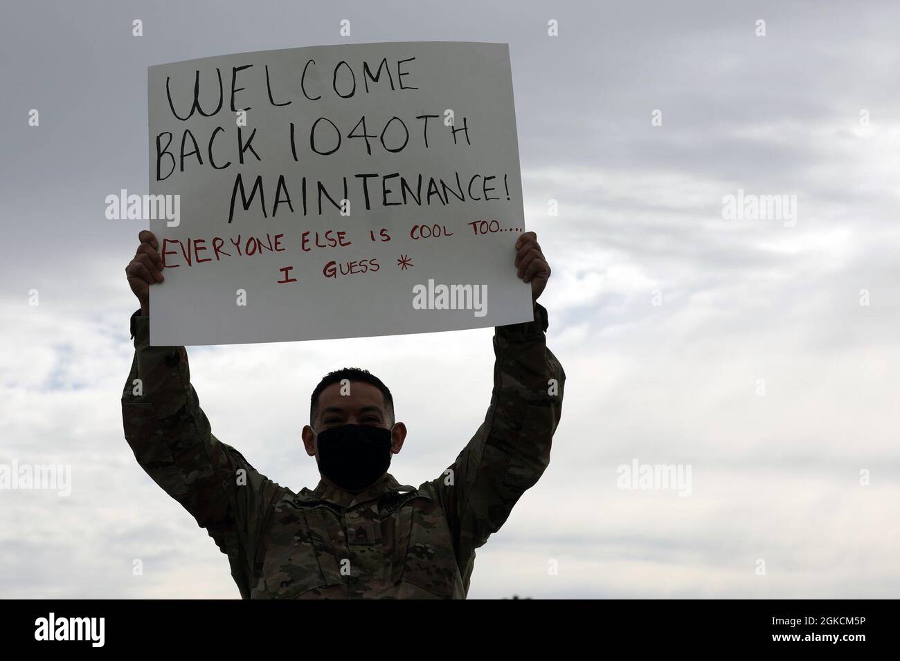 U.S. Army Staff Sgt. Martin Muneton, motor sergeant for the California Army National Guard’s 1040th Quartermaster Company, 340th Brigade Support Battalion, 115th Regional Support Group, lifts a welcome back sign as 40-plus troops arrive at Stockton Metropolitan Airport March 14, 2021 after a two-month mission in Washington, D.C. to support the Jan. 6 presidential inauguration. Stock Photo