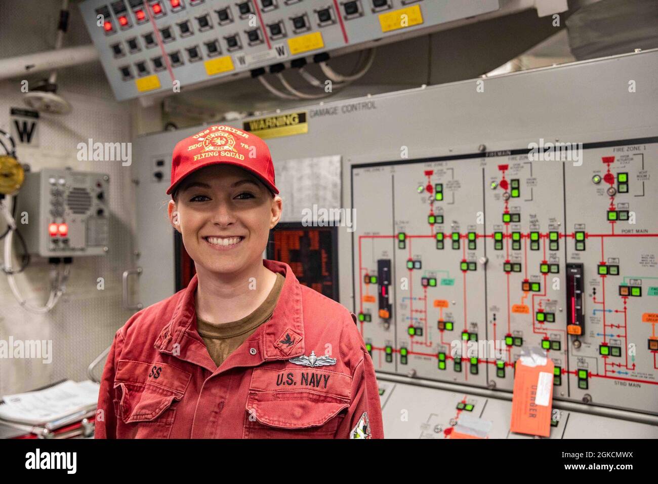 210314-N-BM428-0119 ROTA, Spain (March 14, 2021) Damage Controlman 3rd Class Ashley Bass poses for a photo in front of the damage control console aboard the Arleigh Burke-class guided-missile destroyer USS Porter (DDG 78) while the ship returns to Rota, Spain, March 14, 2021. Porter, forward deployed to Rota, Spain, is on its ninth patrol in the U.S. Sixth Fleet area of operations in support of U.S. national interests and security in Europe and Africa. Stock Photo