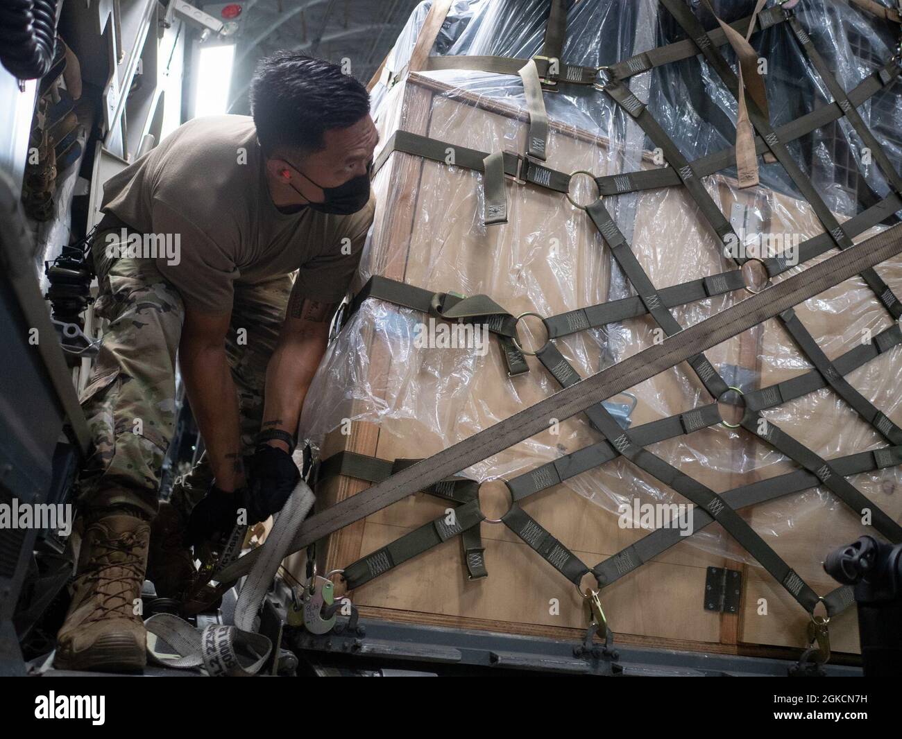 Tech. Sgt. Dennis Dedicatoria, 154th Logistics Readiness Squadron air transportation specialist, secures a pallet on a C-17 Globemaster III March 14, 2021 at Joint Base Pearl Harbor-Hickam, Hawaii. Support personnel were airlifted to Marine Corps Air Station Iwakuni, Japan, to rendezvous with Hawaii-based F-22 Raptors and conduct training operations with U.S. Marine Corps units. Pacific Air Forces’ fighters stand ready to support the global strategic environment as it continues to demand flexibility and freedom of action. Stock Photo