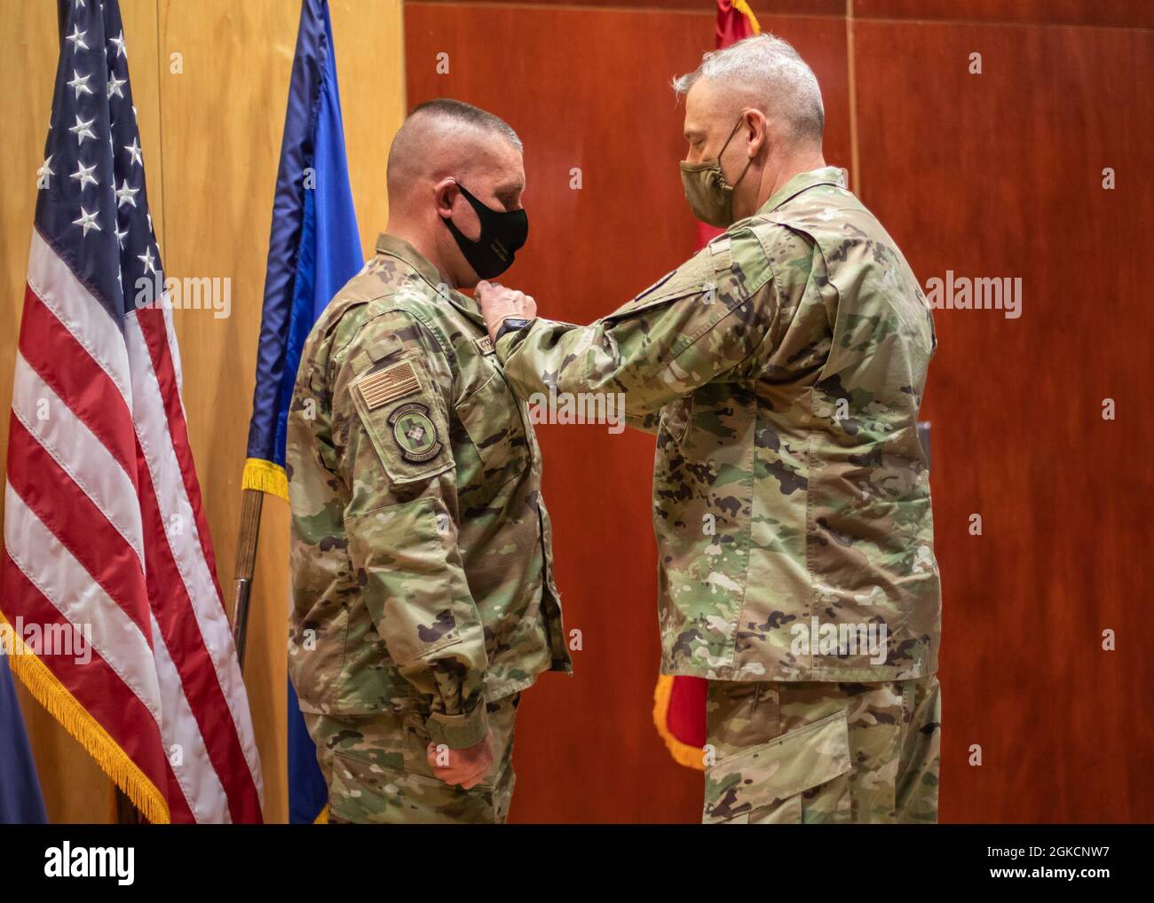 Tech. Sgt. Erik Bornemeier, a medical technician assigned to the 151st Medical Group, Detachment 1, receives the Utah Cross from The Adjutant General of the Utah National Guard Maj. Gen. Michael J. Turley on March 15, 2021 at Roland R. Wright Air National Guard Base, Utah. The Utah Cross is the second highest state award that an Utah National Guard military member can receive. Stock Photo