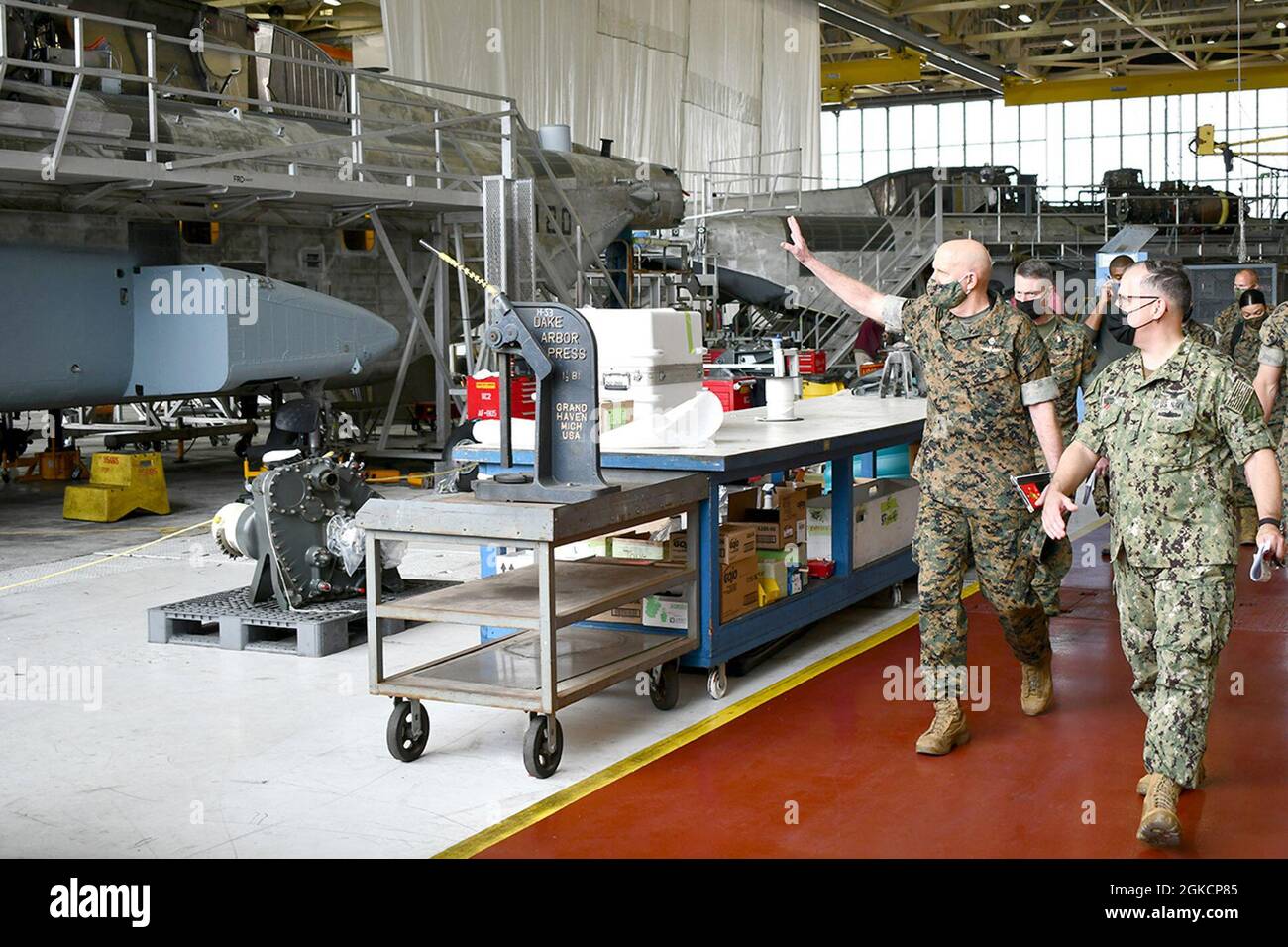 Commandant of the Marine Corps Gen. David H. Berger, left, asks questions about the H-53 heavy-lift helicopter aircraft line at Fleet Readiness Center East while touring the facility March 15 with FRCE Commanding Officer Capt. Mark E. Nieto, right. Berger and Sgt. Maj. of the Marine Corps Troy E. Black visited FRCE to receive updates regarding the support FRCE provides to Marine Corps aviation and the facility’s current status of operations. Stock Photo