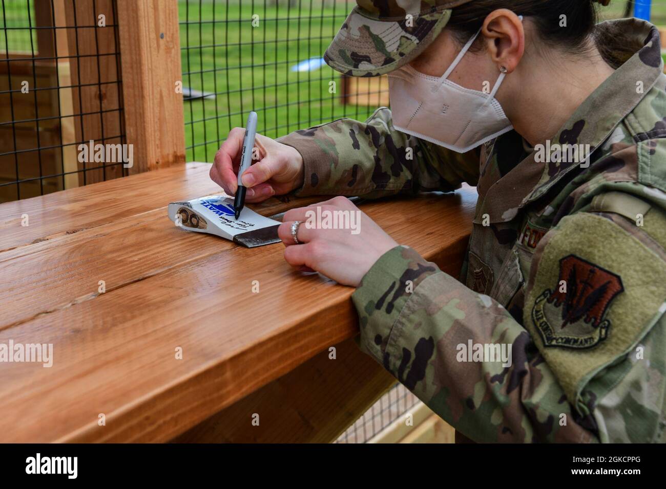 Chief Master Sgt. Tori Jones, wing command chief, signs an axe during
