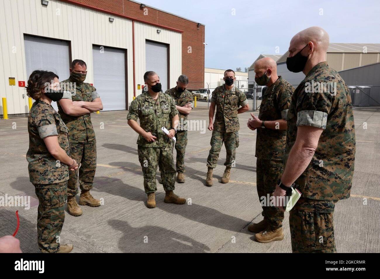 The 38th Commandant of the Marine Corps, Gen. David H. Berger and 19th Sergeant Major of the Marine Corps, Sgt. Maj. Troy E. Black, speak with Navy Capt. Mark E. Nieto, Fleet Readiness Center East Commanding Officer, Marine Corps Air Station Cherry Point, N.C., March 15, 2021. The purpose of the visit was to receive an update from the FRC-East on how they meet the challenge of keeping Naval aviation maintained and ready to respond. Stock Photo