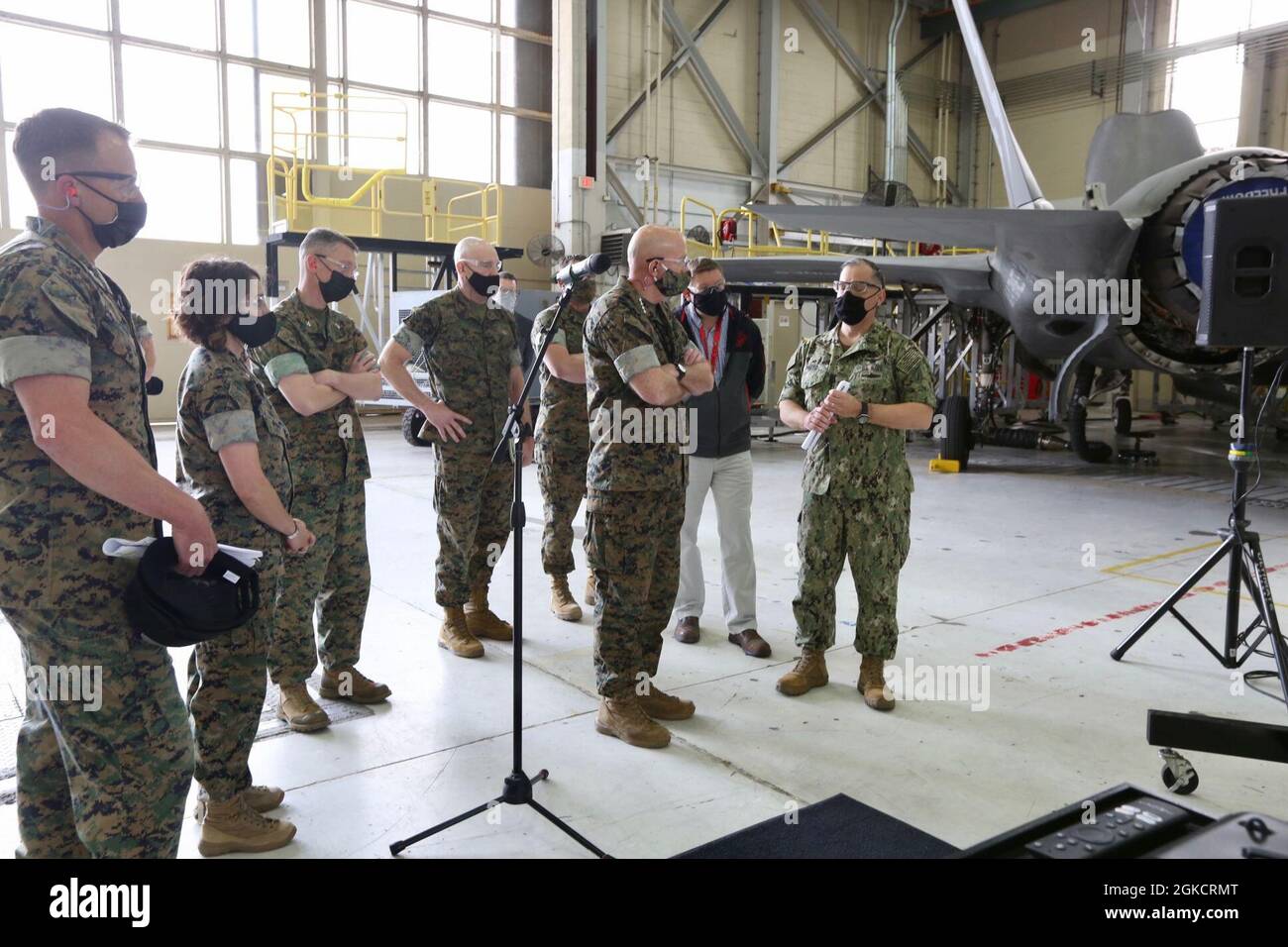 The 38th Commandant of the Marine Corps, Gen. David H. Berger and 19th Sergeant Major of the Marine Corps, Troy E. Black, speak with Navy Capt. Mark E. Nieto, Fleet Readiness Center East Commanding Officer, Marine Corps Air Station Cherry Point, N.C., March 15, 2021. The purpose of the visit was to receive an update from the FRC-East on how they meet the challenge of keeping Naval aviation maintained and ready to respond. Stock Photo