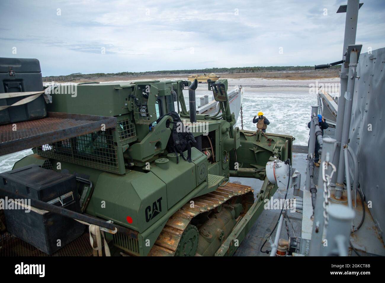 Boatswain’s Mate Third Class Petty Officer Kyle Galiza guides the