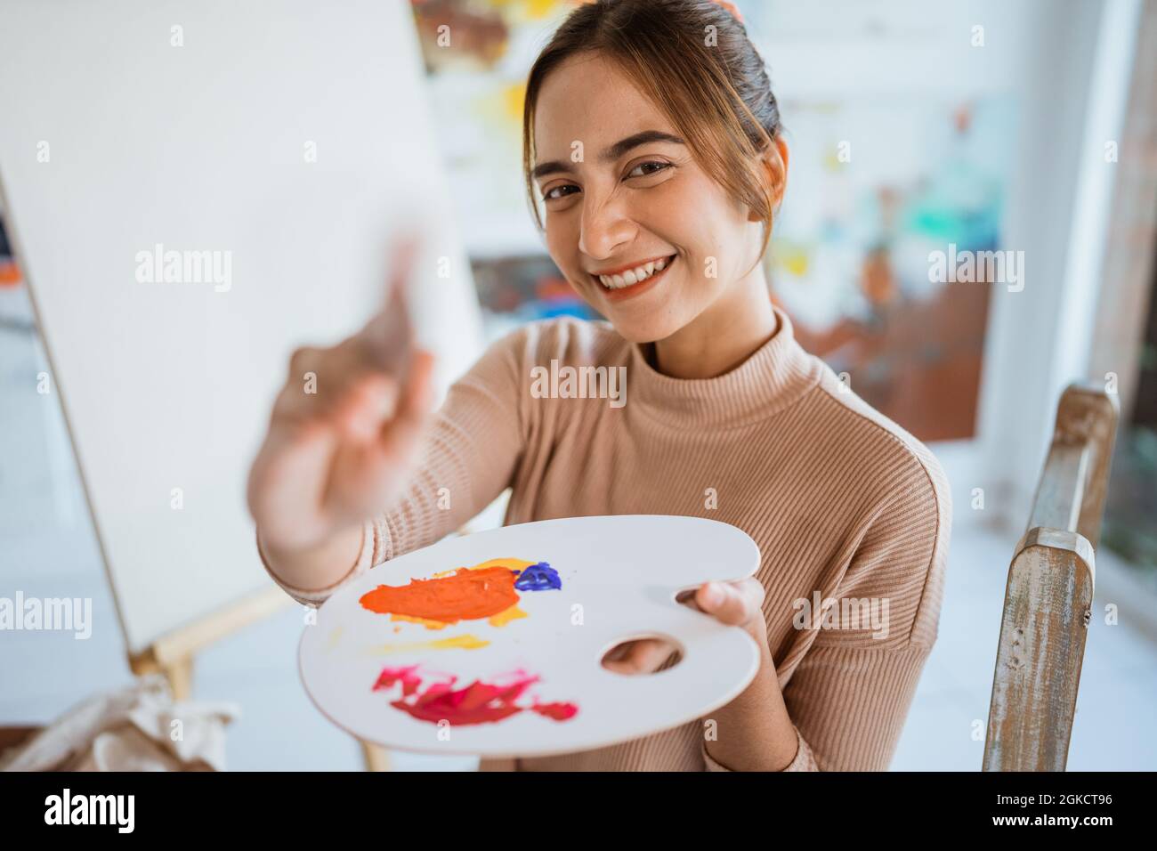 asian female artist painting on canvas doing art projects on her studio ...