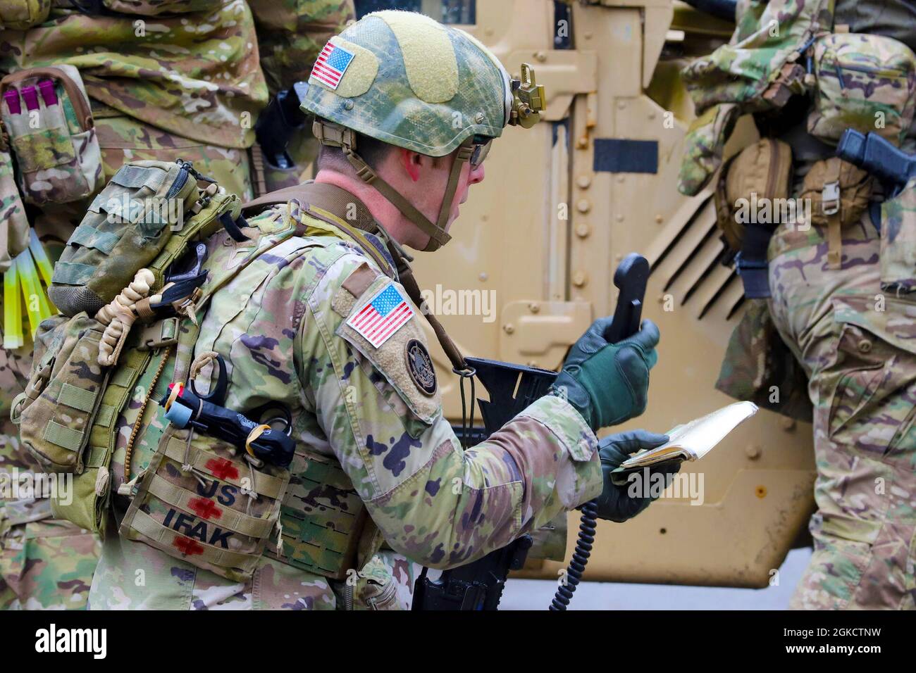 A Soldier with 4th Psychological Operations Battalion uses a loudspeaker  during a raid exercise alongside Green Berets with 5th Special Forces Group  (Airborne) at the Muscatatuck Urban Training Center, Indiana, March 15,