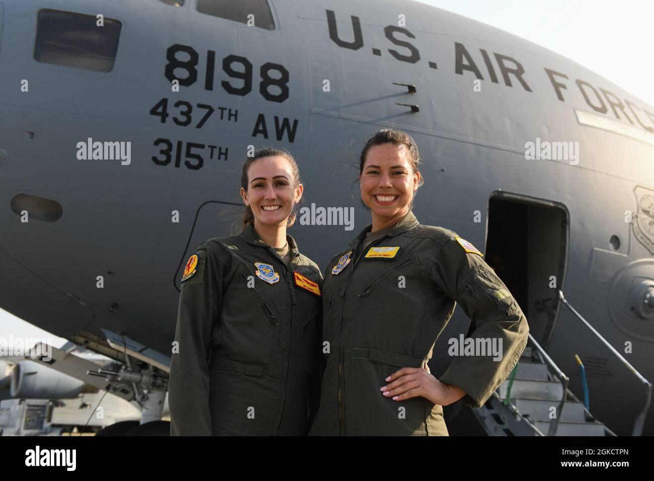 U.S. Air Force 1st Lt. Mia Ahner, and Capt. Sofia Schmidt pose in front of  a C-17 Globemaster III at Joint Base Charleston, S.C. March 15, 2021. The  437th Airlift Wing held