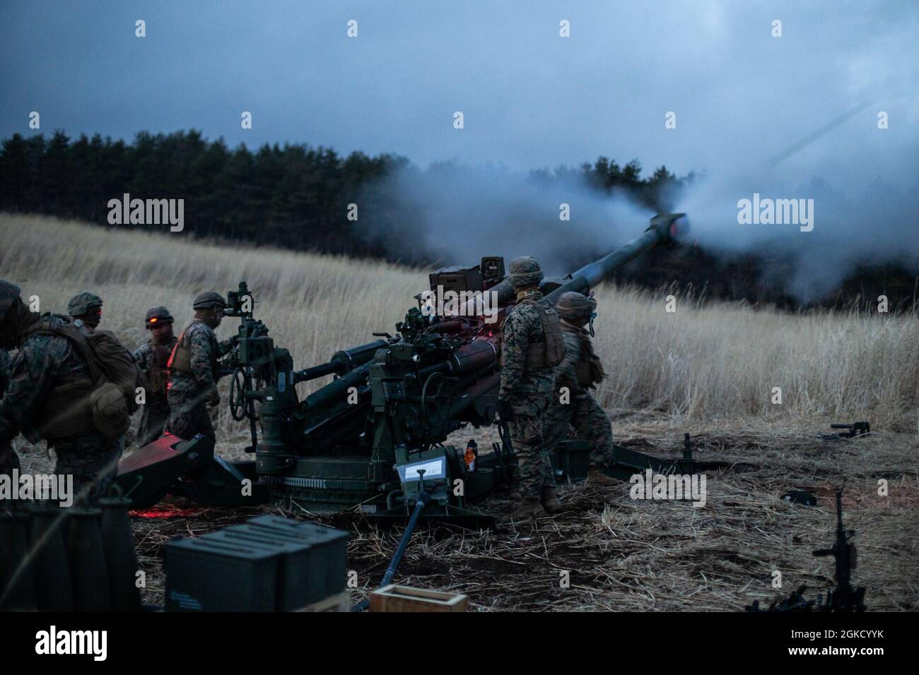 U.S. Marines with Echo Battery, Battalion Landing Team 3/4, 31st Marine Expeditionary Unit (MEU), fire an M777 towed 155 mm howitzer during an indirect fire range at Combined Arms Training Center Camp Fuji, Japan, March 16, 2021. Indirect fire is performed by calculating and adjusting azimuths and inclinations on the M777 Howitzer and utilizing forward observers to call for and adjust fire on targets. The 31st MEU, the Marine Corps’ only continuously forward-deployed MEU, provides a flexible and lethal force ready to perform a wide range of military operations as the premier crisis response fo Stock Photo