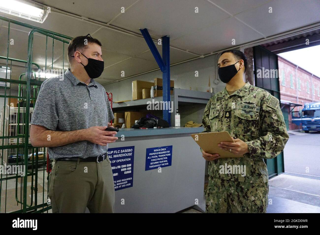 SASEBO, Japan (March 16, 2021) - NAVSUP Fleet Logistics Center Yokosuka  Regional Postal Manager James Clark (left) and Sasebo Post Office Leading  Chief Petty Officer Ronnel Ramos (right) review a checklist during
