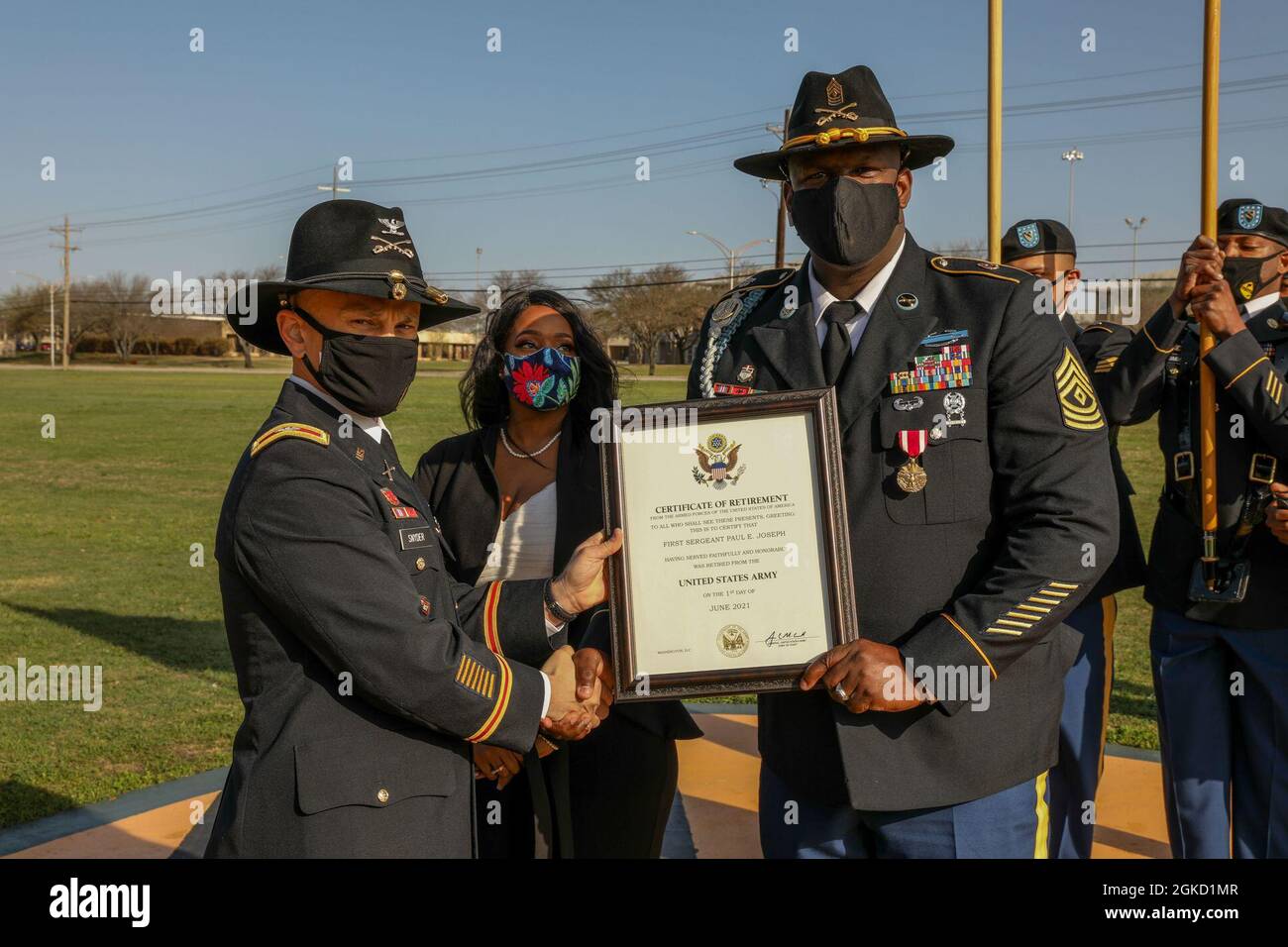 Col. Neil Snyder, 1st Cavalry Division Artillery commander, pose with First Sergeant Paul E. Joseph and his wife, Veronica, after receiving his Certificate of Retirement during the division's Distinguished Service Recognition Ceremony on Cooper Field, Fort Hood, TX, March 17, 2021. Stock Photo