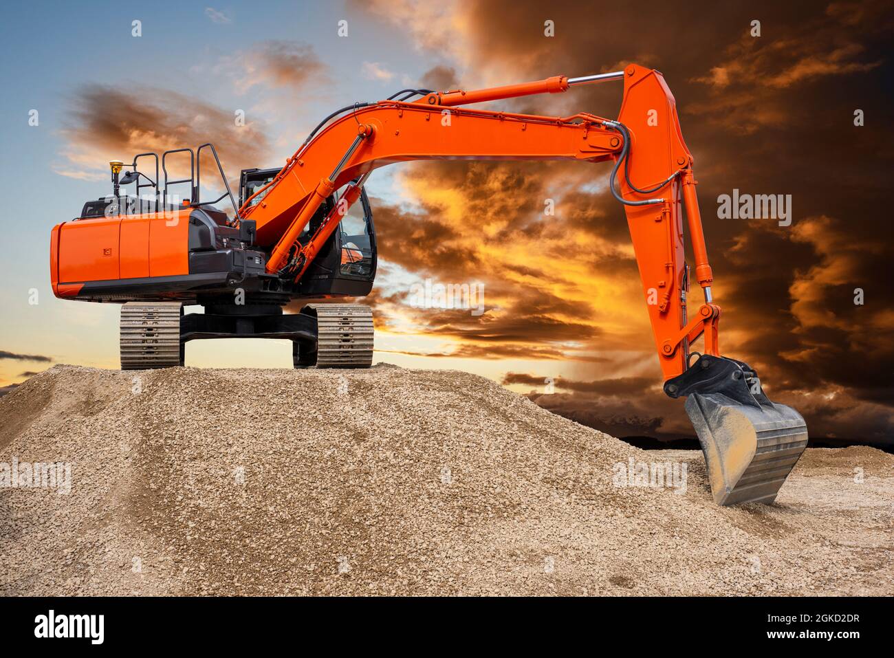 excavator working on construction site with dramatic clouds on sky ...