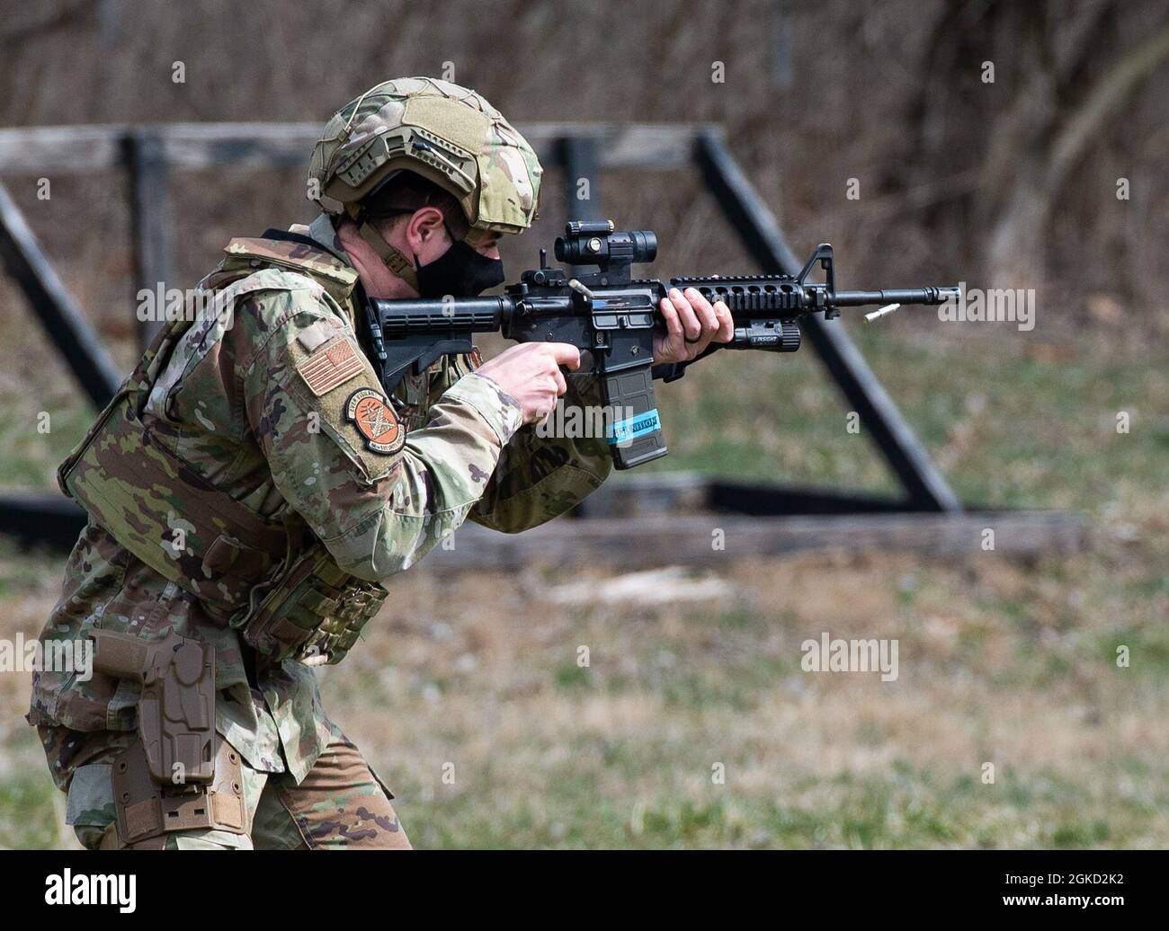 A member of the 88th Security Forces Squadron fires a simunition round ...