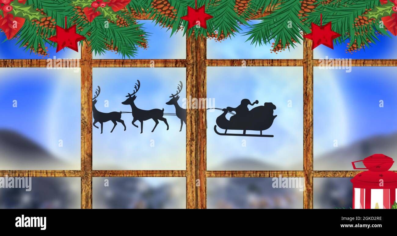 Digital image of christmas decoration of wooden window frame against black silhouette of santa c Stock Photo