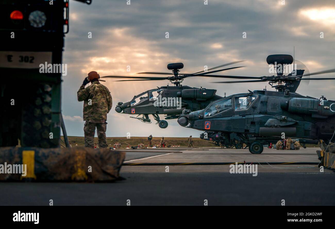 U.S. Army Spc. Brian Johnson, an ammunition specialist assigned to the 12th Combat Aviation Brigade, watches as a fully-fueled AH-64 launches from the forward area rearming and refueling point during Operation Eminent Strike on Mar. 17, 2021, at Katterbach Army Airfield. Stock Photo