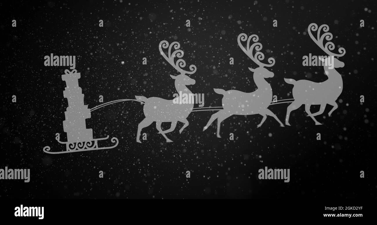 Digital image of snow falling over silhouette of christmas gifts in sleigh Stock Photo