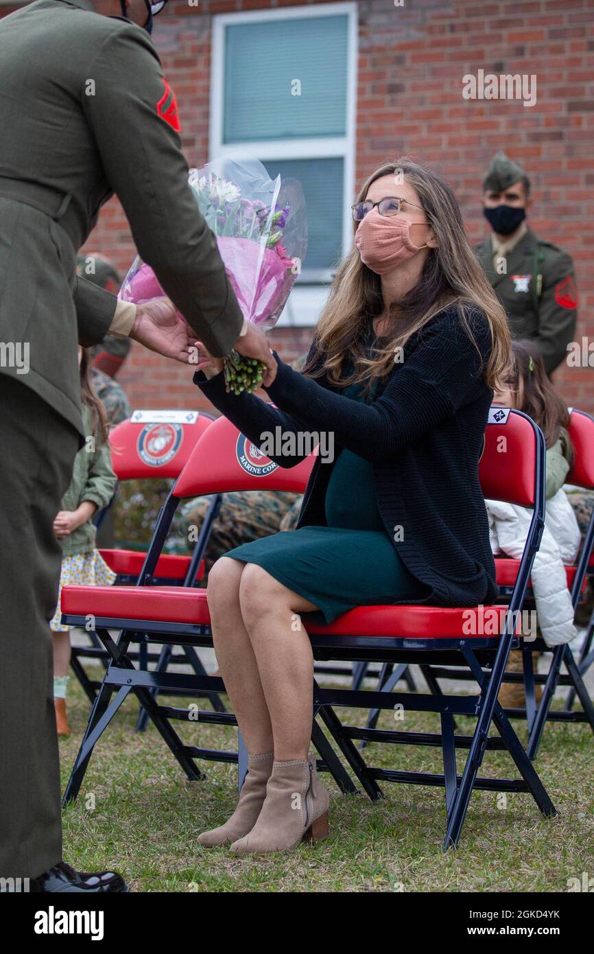 Nichole Loftus, wife of Sgt. Maj. Anthony J. Loftus, off-going sergeant major, 6th Marine Regiment, 2d Marine Division (2d MARDIV), receives flowers during a relief and appointment ceremony on Camp Lejeune, N.C., March 17, 2021. Loftus served as 6th Marine Regiment sergeant major for two years and now retires afteryears of faithful service. Stock Photo