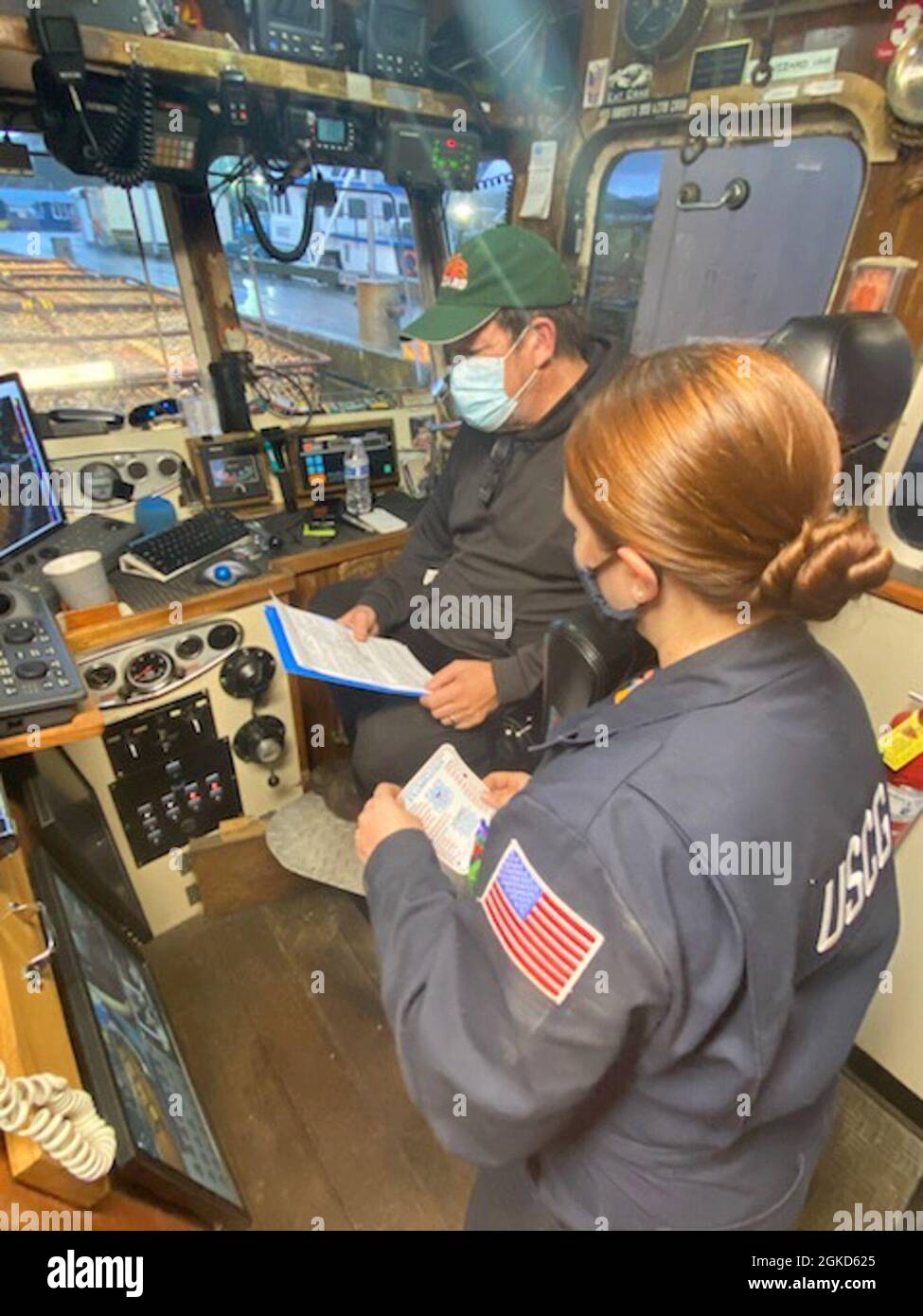 Petty Officer 1st Class Sarah Jacobs Issues A Commercial Fishing Vessel Safety Decal To The Operator Aboard Fishing Vessel Wizard Prior To The Opening Of Crab Season After Completing A Safety Compliance