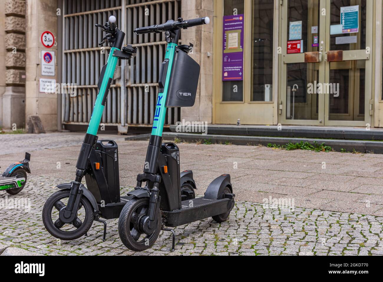 standing electric escooter or e-scooter of the company TIER on the sidewalk Berlin Stock - Alamy