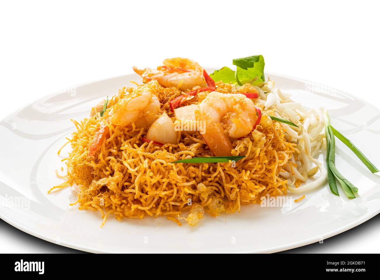 Closeup view of homemade crispy fried rice noodles with shrimp, bean sprout and garlic in white ceramic plate isolated on white background with clippi Stock Photo