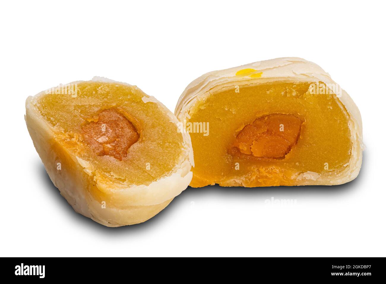Two halves of chinese patry or moon cake filled with mashed mung bean and salted egg yolk on white background with clipping path. Stock Photo