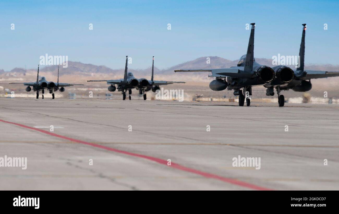 Three F-15SG Strike Eagle's assigned to the 428th Fighter Squadron, taxi down the flightline at Nellis Air Force Base, Nevada, March 19, 2021. The Republic of Singapore Air Force participated in Red Flag 21-2, training in advanced aerial combat scenarios with the U.S. Air Force, Sweden and several NATO nations. Stock Photo