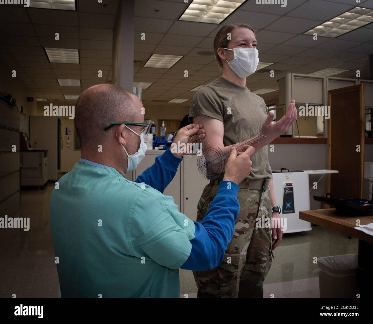 Kelly Jones, certified occupational therapy assistant, measures a