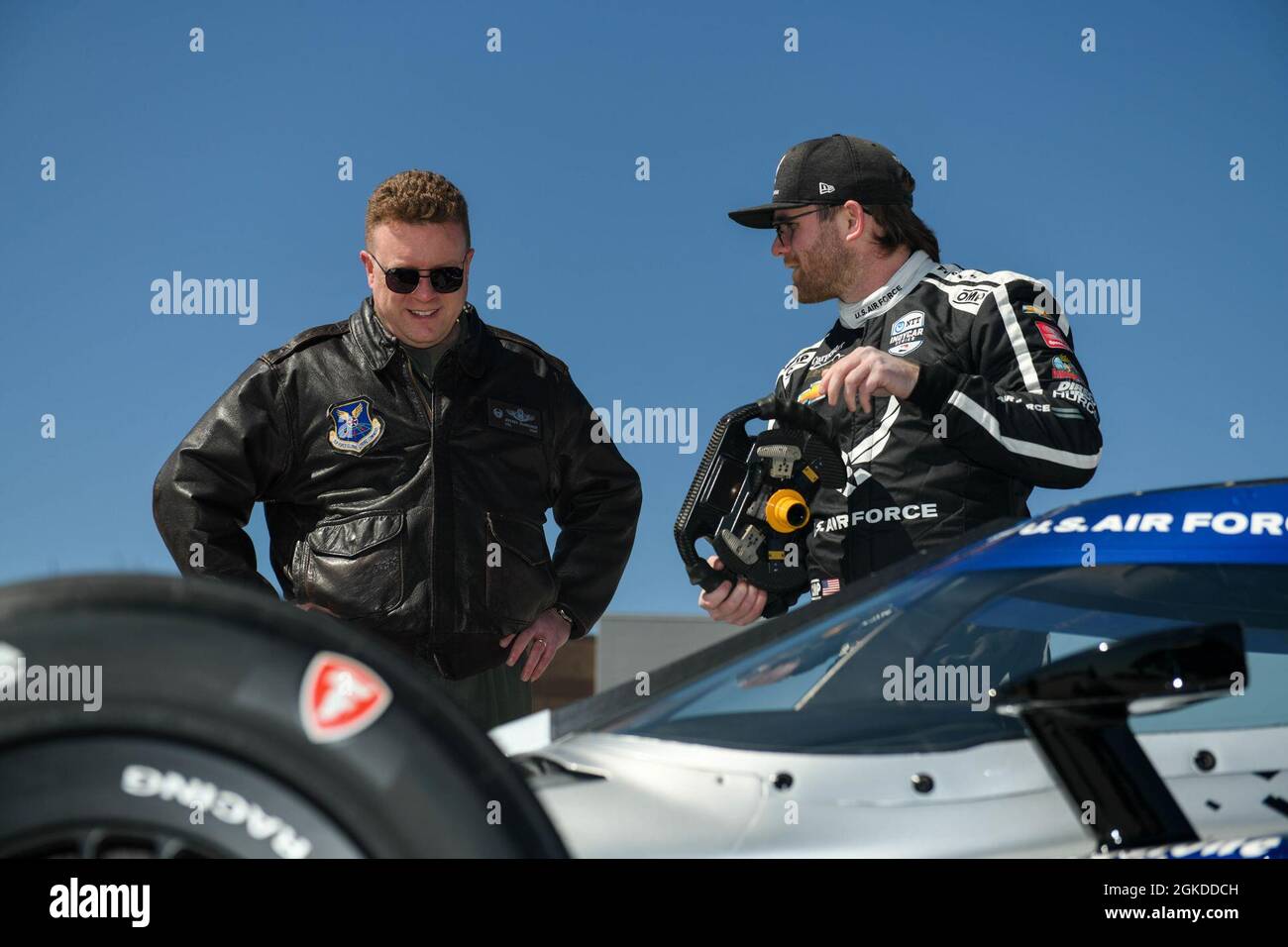 U.S. Air Force Col. Jeffery Schreiner, 509th Bomb Wing commander and Conor Daly, an Indy Car driver with Ed Carpenter Racing talk about the U.S. Air Force and Space Force Recruiting service's No. 20 Indy Car at Whiteman Air Force Base, Missouri, Mar. 19, 2021. The recruiting team partner with Ed Carpenter Racing to design the No. 20 Indy Car with a B-2 Spirit paint scheme. Stock Photo