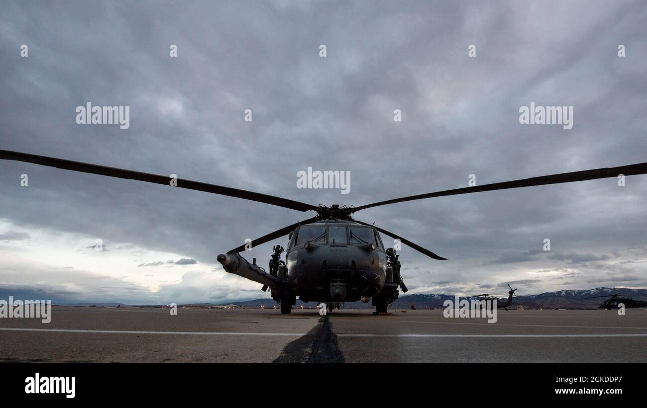 An HH-60 Pave Hawk poses for a sunrise portrait before a training flight at Gowen Field, Boise, Idaho. The helicopters are in Idaho to support an exercise with multiple rescue squadrons and the 190th Fighter Squadron. Stock Photo