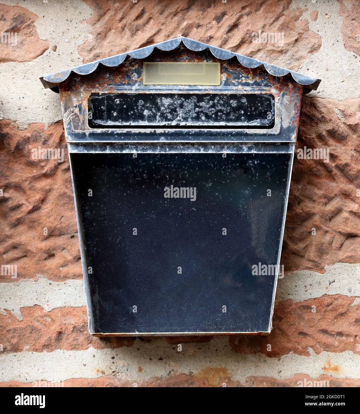 Old metal mail box situated on a town building wall Stock Photo - Alamy