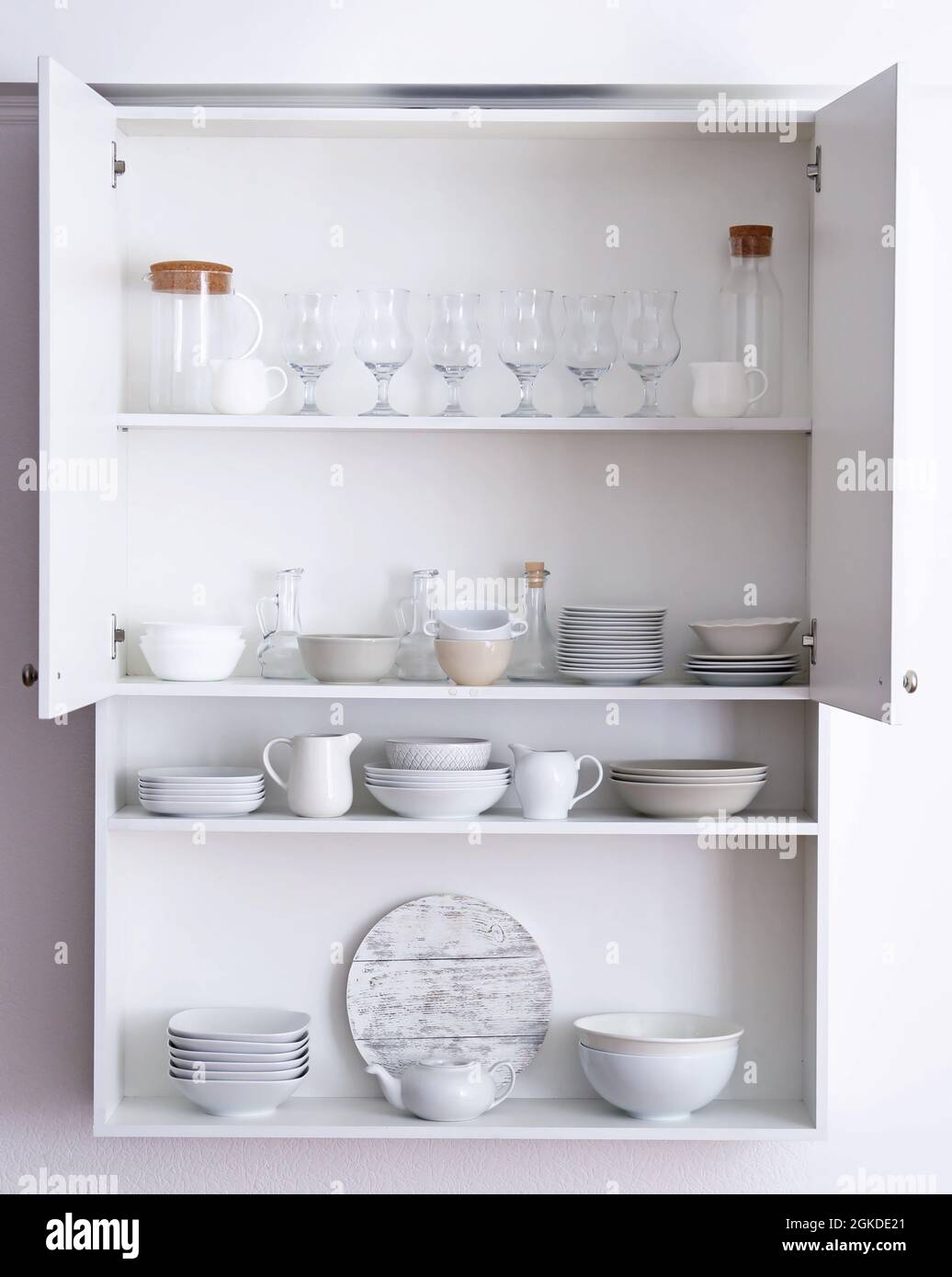 Kitchen cupboard with different clean dinnerware Stock Photo Alamy