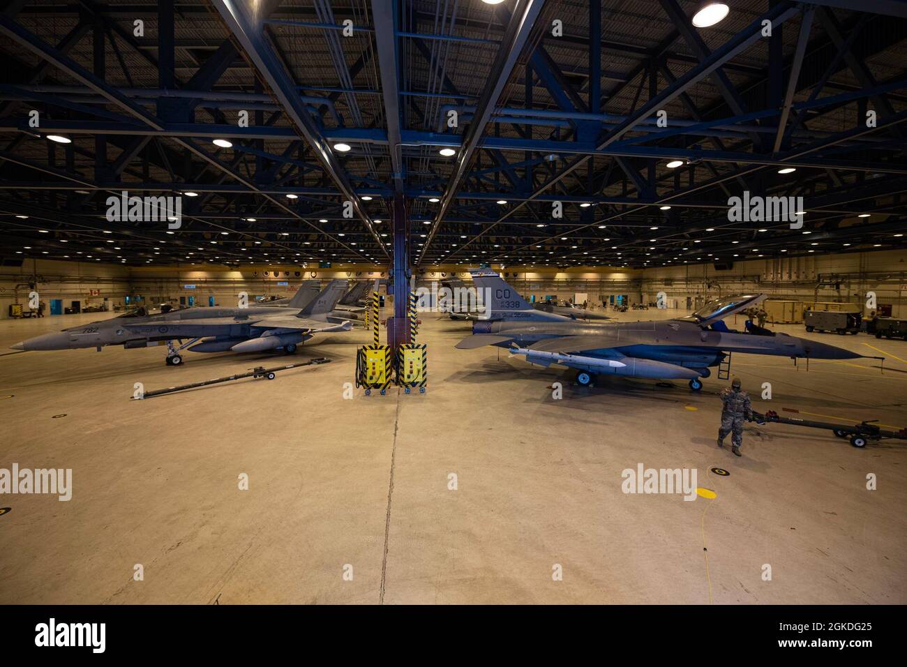 Royal Canadian Air Force CF18s and U.S. Air Force F16s share hangar