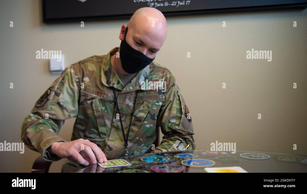 Tech Sgt. Adam Wilkinson, 8th Air Force and Joint Global Strike Operations Center deputy chief of nuclear command, control and communication threats goes through a stack of empowering cards at Barksdale Air Force base, La., Feb. 23, 2021. Tech Sgt. Wilkinson had the opportunity to shadow Chief Smith for a day. Stock Photo