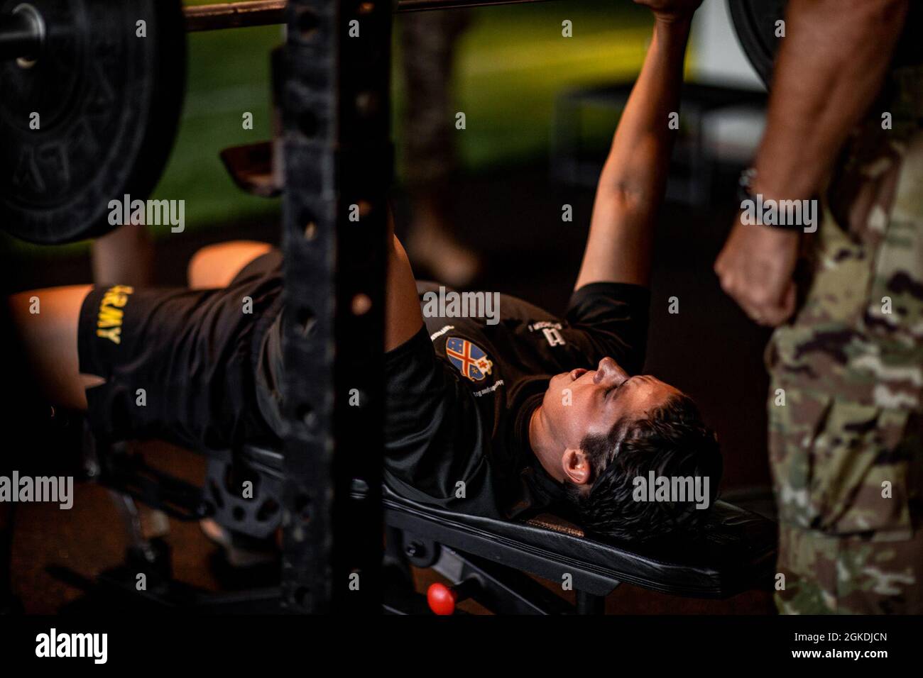 Cpt. Jillian Jones, commander of Echo Company, 29th Engineer Battalion, 3rd Infantry Combat Team, Infantry Division conducts a body weight bench press for max repetition as part of the