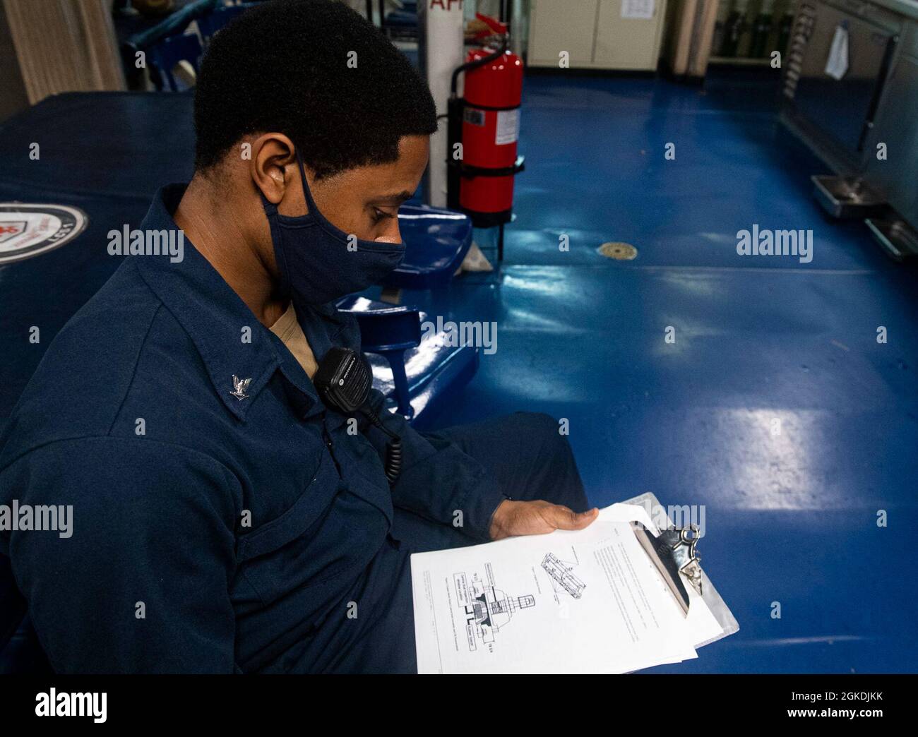 210322-N-RC007-1003 RODMAN, PANAMA (March 22, 2021) Engineman 3rd Class Elijah Lamb from Dallas, Texas, reviews a maintenance requirement card aboard the Freedom-variant littoral combat ship USS Freedom (LCS 1) during a brief stop for fuel and provisions in Rodman, Panama, March 22, 2021. Freedom is deployed to the U.S. 4th Fleet area of operations to support Joint Interagency Task Force South's mission, which includes counter-illicit drug trafficking missions in the Caribbean and Eastern Pacific. Stock Photo