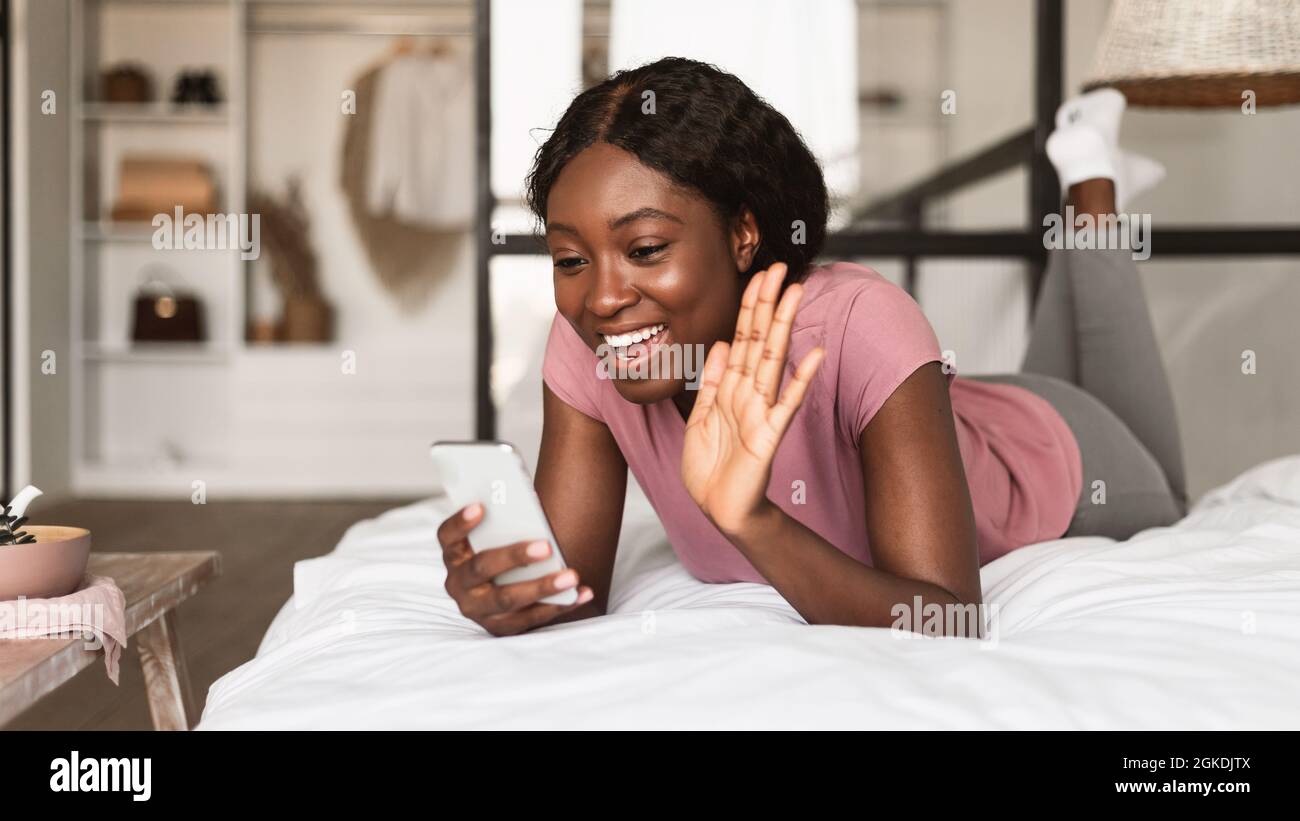 African American Lady Video Calling Via Cellphone Lying In Bedroom ...