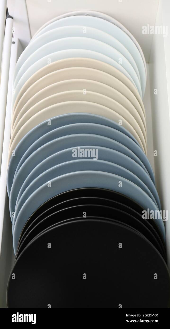 Set of plates in kitchen drawer Stock Photo Alamy
