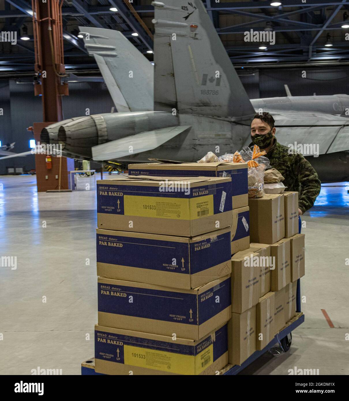 MCpl HernandezTremblay delivers meals to U.S. Air Force personnel