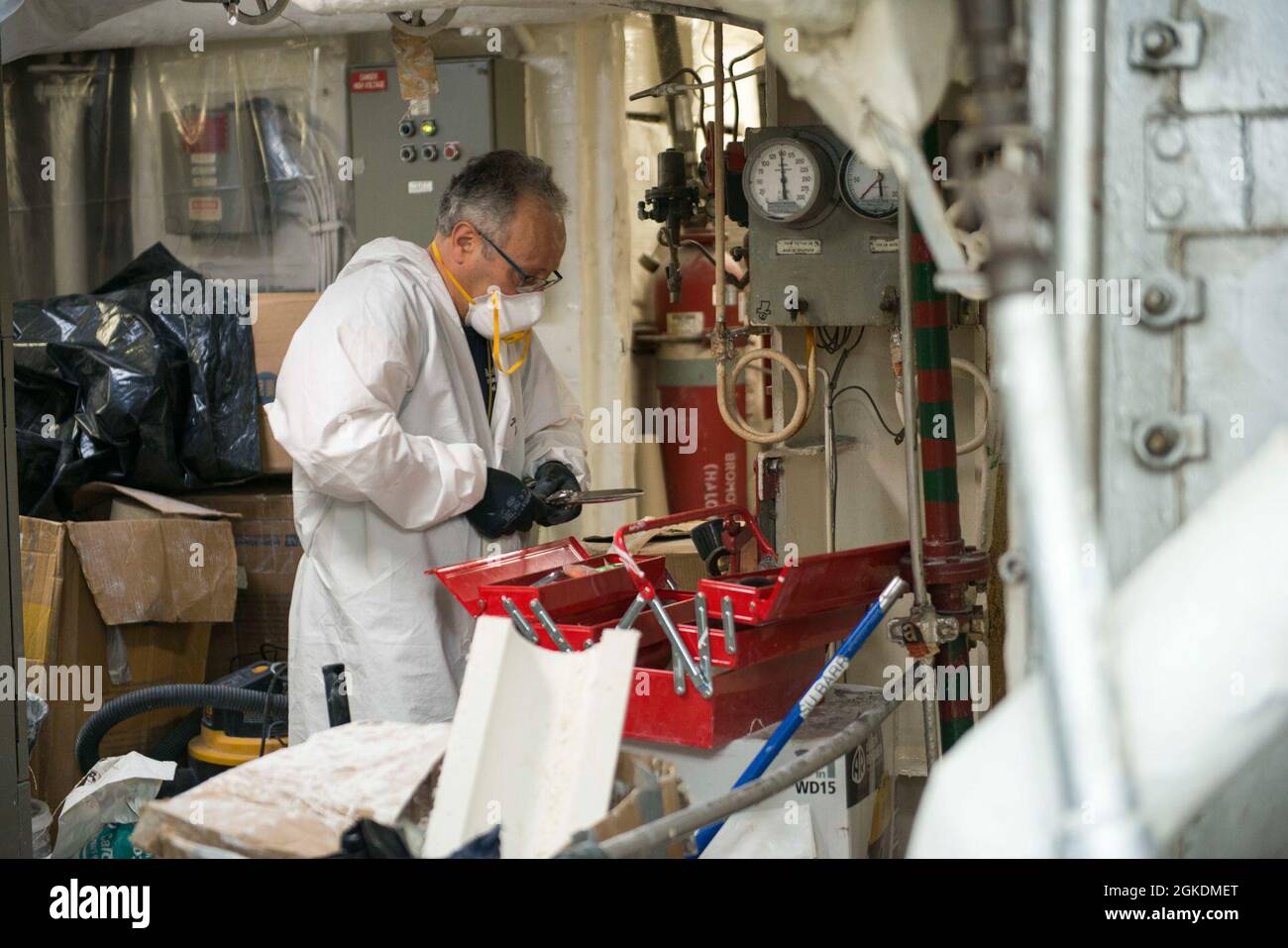 210323-N-EI510-0038 GAETA, Italy (March 23, 2021) An Italian contractor fixes a tool during a repair aboard the Blue Ridge-class command and control ship USS Mount Whitney (LCC 20) in Gaeta, Italy, March 23, 2021. Mount Whitney, forward deployed to Gaeta, Italy operates with a combined crew of Sailors and Military Sealift Command civil service mariners in the U.S. Sixth Fleet area of operations in support of U.S. national security interests in Europe and Africa. Stock Photo