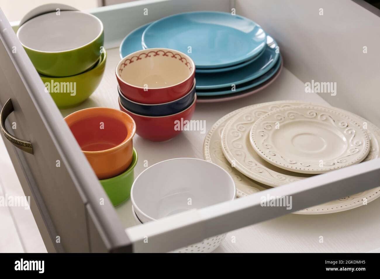 Set of tableware in kitchen drawer Stock Photo Alamy