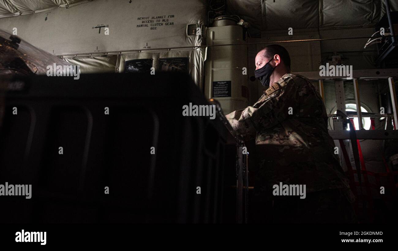 An Airman loads cargo onto an HC-130J Combat King II at Springfield-Beckley Municipal Airport, Ohio, March 23, 2021. The cargo was a LIFT Aircraft electronic vertical takeoff and landing aircraft that the 79th Rescue Squadron transported from Ohio to Texas. This transportation effort served as a proof of concept as the 355th Wing plans to integrate eVTOL into upcoming exercises to further its agile combat employment capabilities. Stock Photo