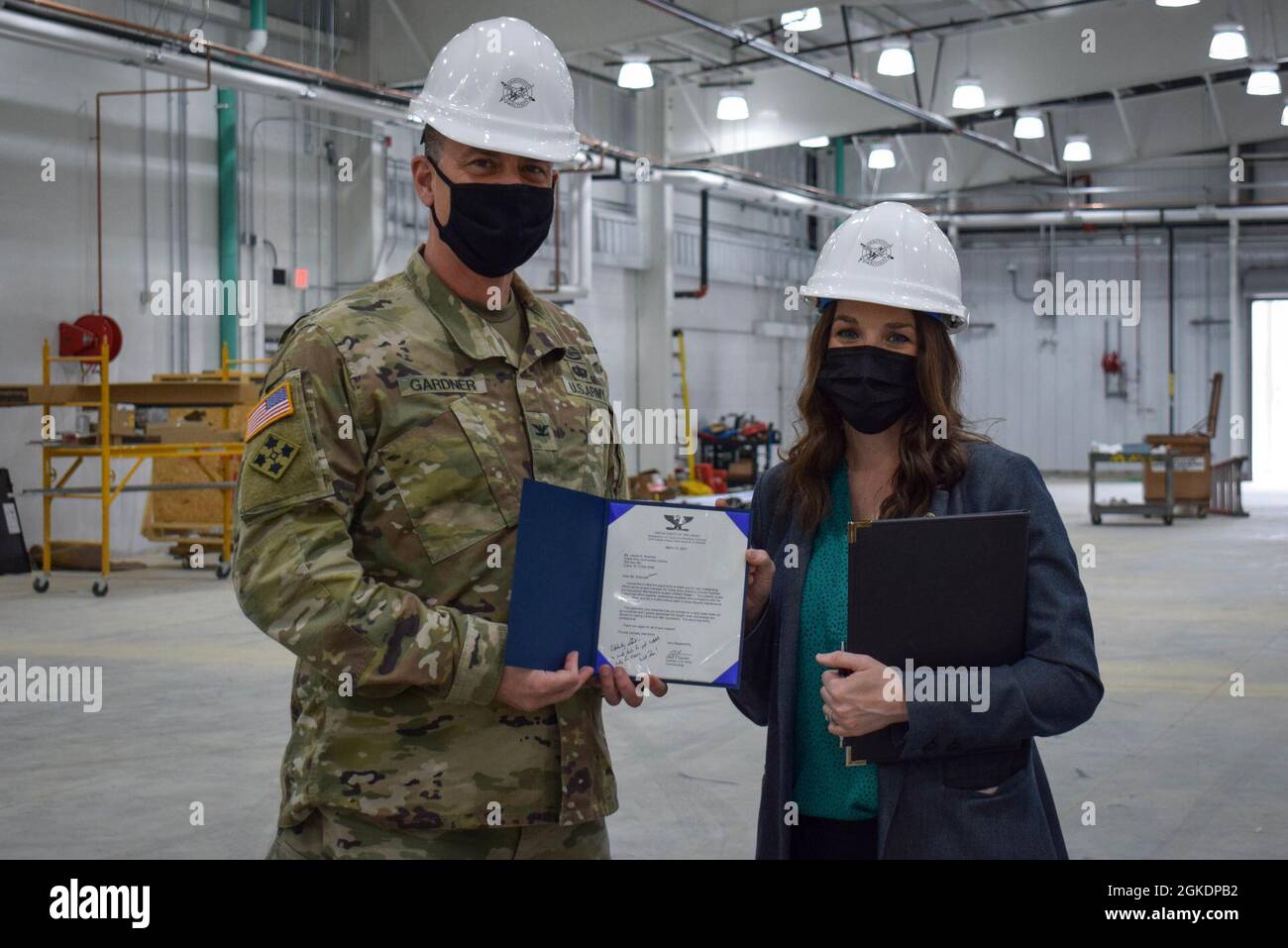 Col. Gavin Gardner, commander of Joint Munitions Command, recognized a variety of Crane Army employees during his visit to the activity, including presenting Lauren Shipman, civil engineer, with a commander’s challenge coin and a commendation letter for her work on the new shipping and receiving facility, slated to open in the summer of 2021. Shipman, Greg Edwards, supervisory supply management specialist, and Matt McGowen, depot operations director, showed Gardner around the facility, which includes in-house inspection bays to streamline the process of moving received munitions to proper stor Stock Photo