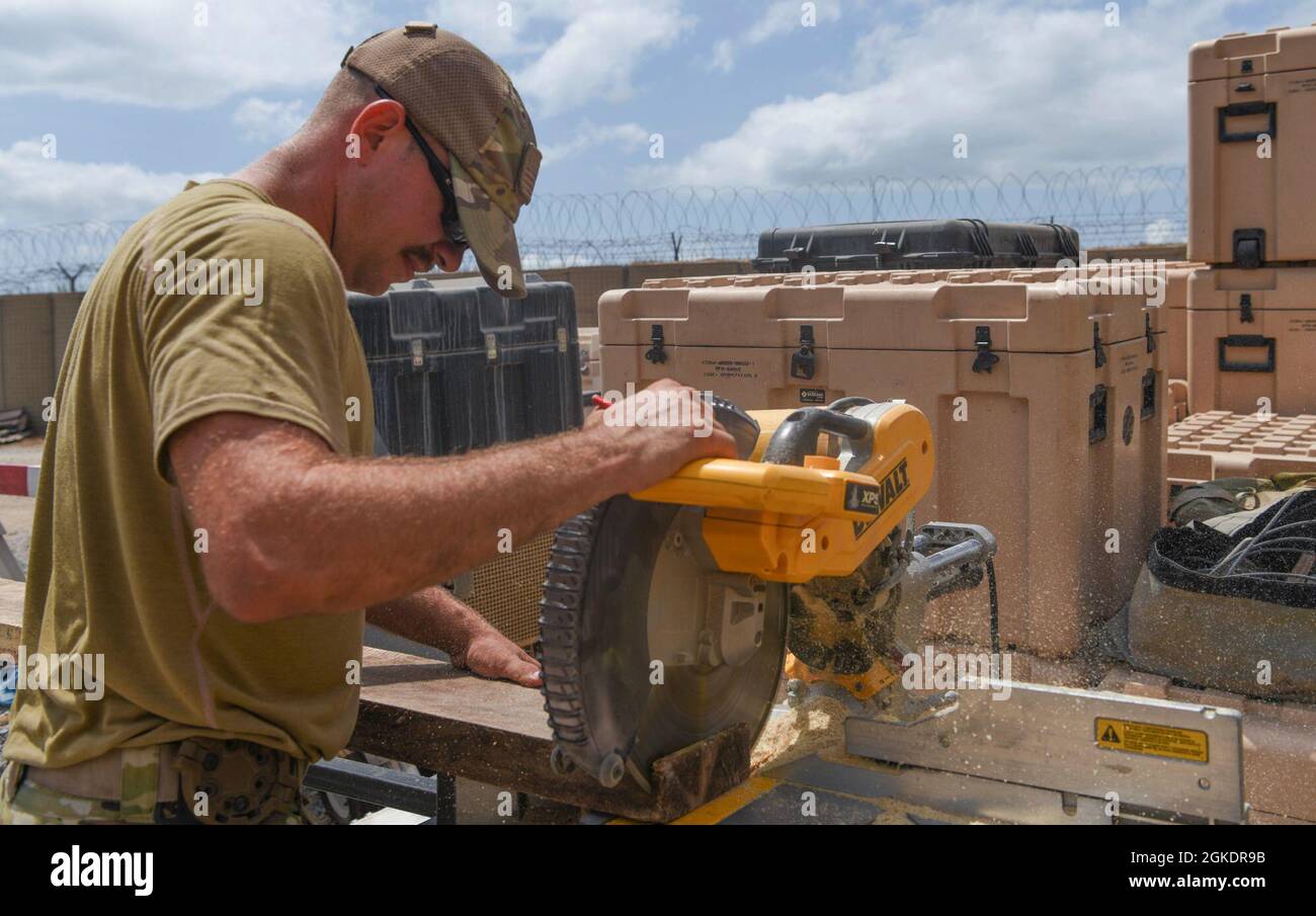 A U.S. Air Force service member assigned to the 786th Civil Engineer Squadron cuts a support beam template March 23, 2021, at Camp Simba, Kenya. Airmen of the 786th CES made various improvements around the base in order to help Camp Simba continue projecting airpower to the Combined Joint Task Force-Horn of Africa area of responsibility. Stock Photo
