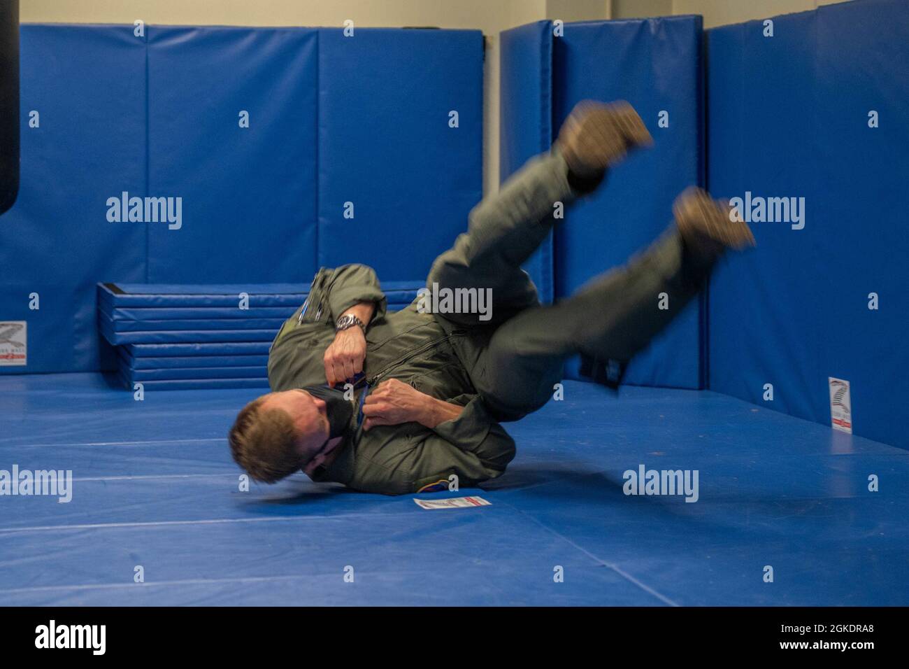 An aircrew member demonstrates the proper technique for landing while