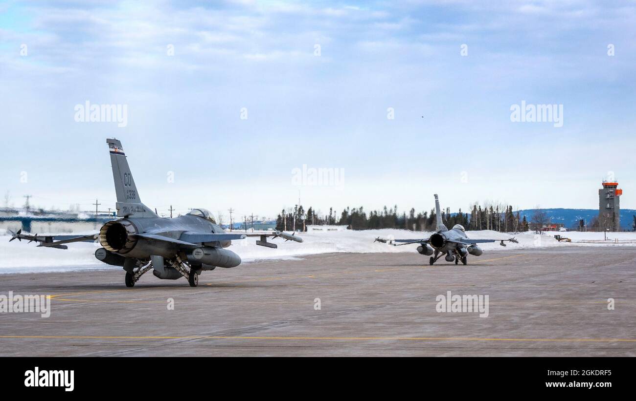 Two Colorado Air National Guard F-16 Fighting Falcons from the 140th Wing leave for take off at Canadian Forces Base Goose Bay during exercise Amalgam Dart 21-02, March 24, 2021. The exercise will run from March 20-26 and range from the Beaufort Sea to Thule, Greenland and extend south down the Eastern Atlantic to the U.S. coast of Maine. Amalgam Dart 21-02 provides NORAD the opportunity to hone homeland defense skills as Canadian, U.S., and NATO forces operate together in the Arctic. A bi-national Canadian and American command, NORAD employs network space-based, aerial and ground based sensor Stock Photo