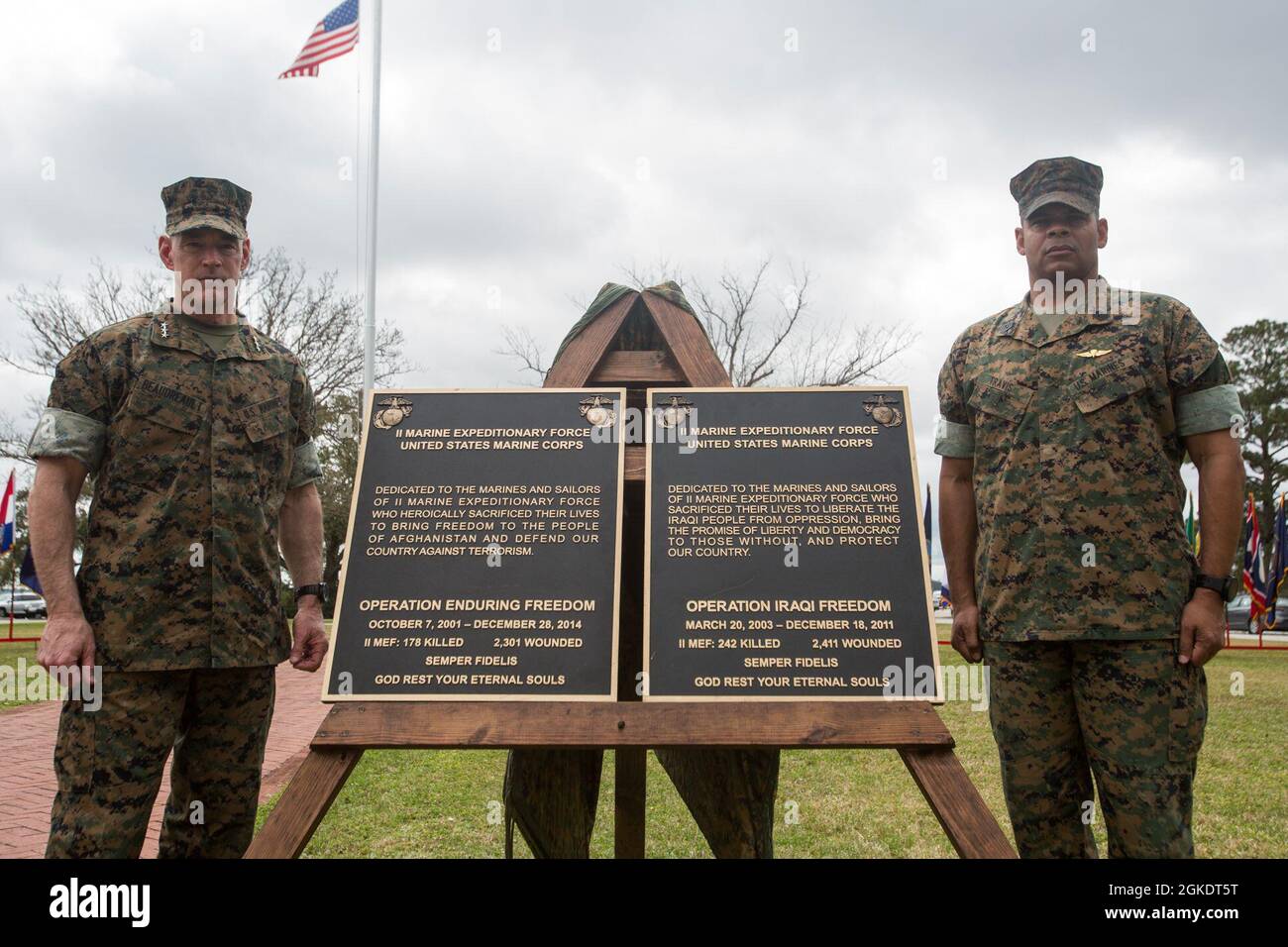 U.S. Marine Corps Lt. Gen. Brian D. Beaudreault, the commanding general of II Marine Expeditionary Force, and Sgt. Maj. Lonnie Travis, the sergeant major of II MEF, pose for a photo in front of the Operation Iraqi Freedom and Operation Enduring Freedom plaques after a dedication ceremony on Marine Corps Base Camp Lejeune, Mar. 24, 2021. This dedication ceremony allows II MEF to carry on the legacy of fallen Marines and sailors by honoring their sacrifice and commemorating their heroic achievement during OIF and OEF. Stock Photo