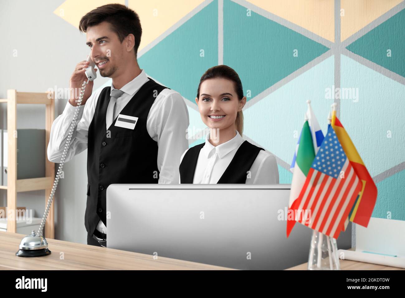 Female and male receptionists working in hotel Stock Photo Alamy