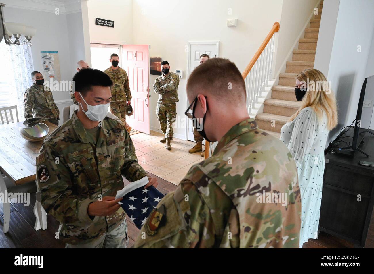 Members of the 1st Combat Camera Squadron (CTCS) from Joint Base Charleston, South Carolina, prepare for a reenlistment ceremony for U.S. Air Force Staff Sgt. David Rhoton, 1st CTCS, client systems supervisor, at his home at Summerville, South Carolina, March 24, 2021. This unique ceremony was held during a video meeting of the Air Force Survivor Advocacy Roundtable and officiated by Air Force Chief of Staff Gen. Charles Q. Brown. Stock Photo