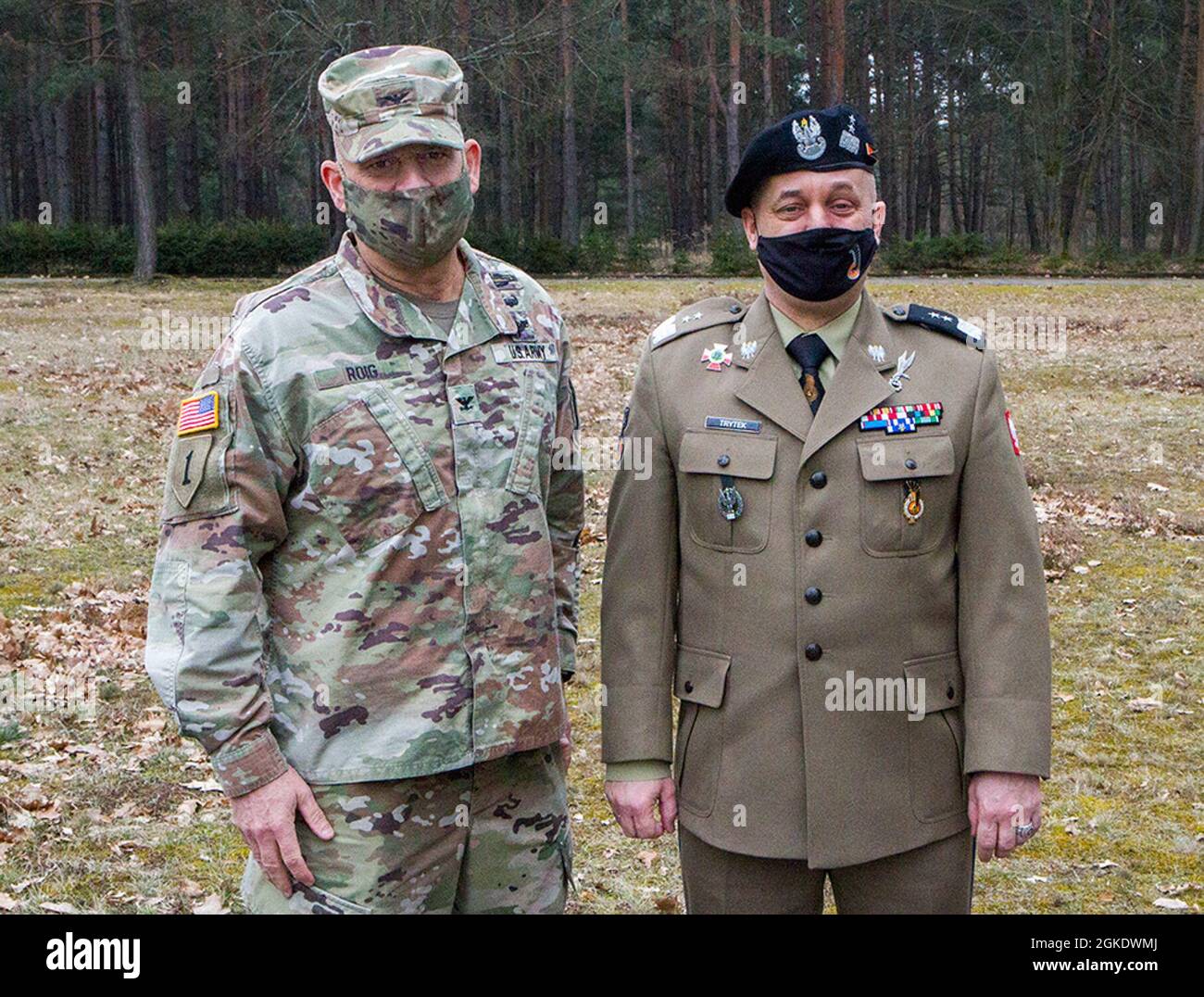 U.S. Army Col. Ricardo Roig (left), 50th Regional Support Group (RSG) commander, meets with Polish army Maj. Gen. Piotr Trytek (right), 11th Armored Cavalry Division commander, during a remembrance ceremony in Zagan, Poland, on Mar. 24, 2021. The ceremony commemorates the efforts of Allied service members who participated in the “Great Escape” from Stalag Luft III, a German prison-of-war camp, in March 1942. The 50th RSG, a Florida Guard unit based in Homestead, Florida, is deployed to Poland to support the European Deterrence Initiative as part of Operation Atlantic Resolve by providing manag Stock Photo