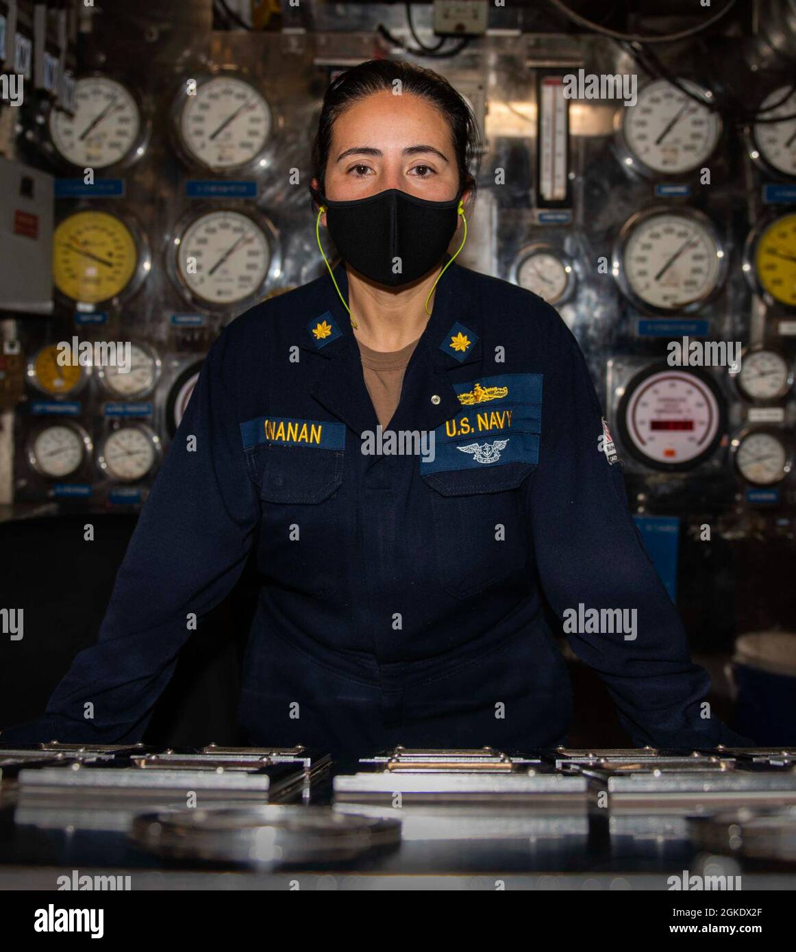East China Sea (Mar. 24, 2021) -  Lt. Cmdr. Patricia Cunanan, from Manila, Philippines, a chief engineering (CHENG) officer poses for a photograph in the fire room aboard U.S. 7th Fleet flagship USS Blue Ridge's (LCC 19)Blue Ridge. Cunanan enlisted in the Navy as a boiler technician in December 1994, then later commissioned through the Limited Duty Officer program. She is currently assigned aboard Blue Ridge as the first female CHENG. Blue Ridge is the oldest operational ship in the Navy and, as 7th Fleet command ship, actively works to foster relationships with allies and partners in the Indo Stock Photo